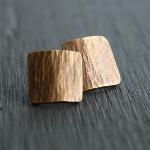 Square Bark Studs. Thick gauge brass with sterling silver posts. Finished with a heat patina for subtle color. $32.00