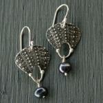 Oxidized sterling silver with the texture of sea urchins, accented with at black pearl.