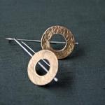 Hammered bronze discs with sterling silver wires.
