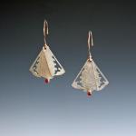 Inspired by the Filipino hand fan, these earrings can be worn as a single panel or spread into three.
14k gold, sterling and ruby.