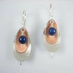 Lapis Pod earrings. Textured sterling silver and copper with lapis beads; slimmer shape than Jade Pods above.
