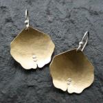 Domed, textured brass with sterling silver accents.
$48.00