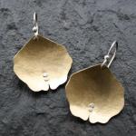 Domed, textured brass with sterling silver accents.
$75.00